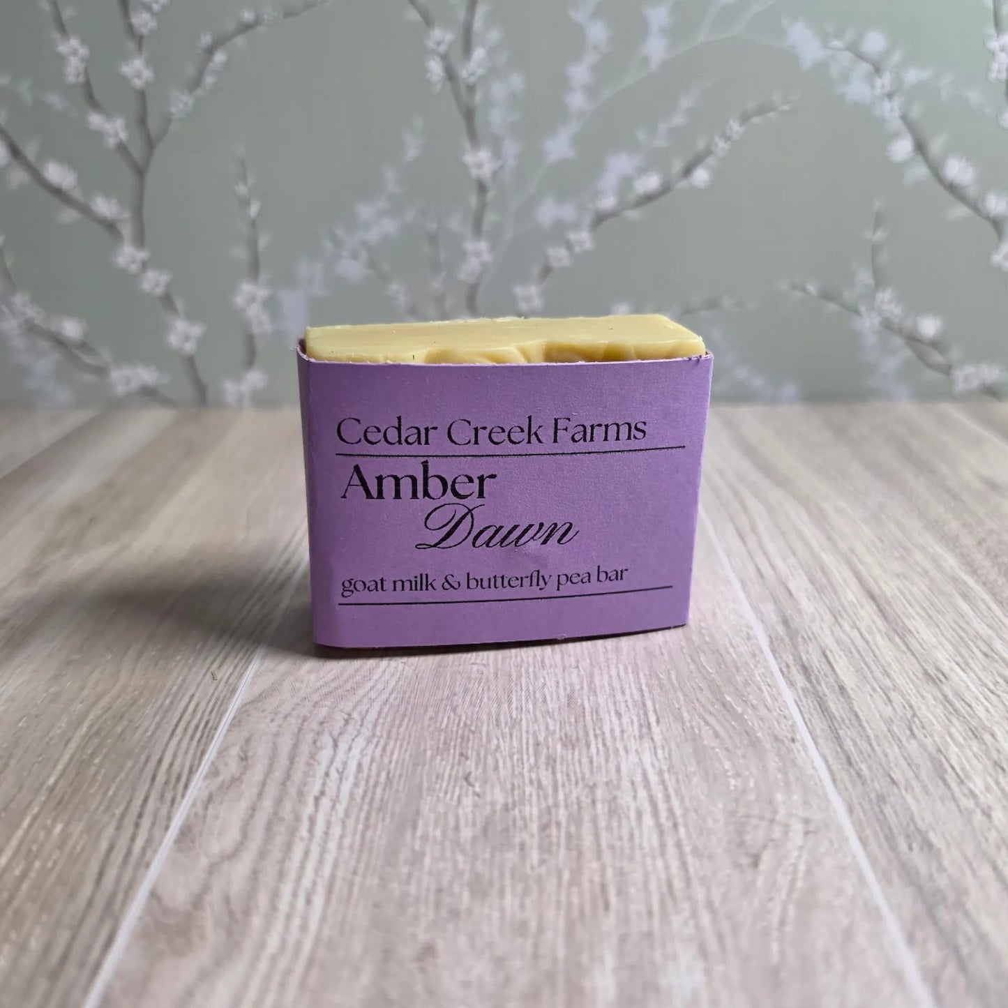 Cedar Creek Farms Amber Dawn soap bar goat milk and butterfly pea with blue and cream swirl, natural handcrafted soap on wood surface