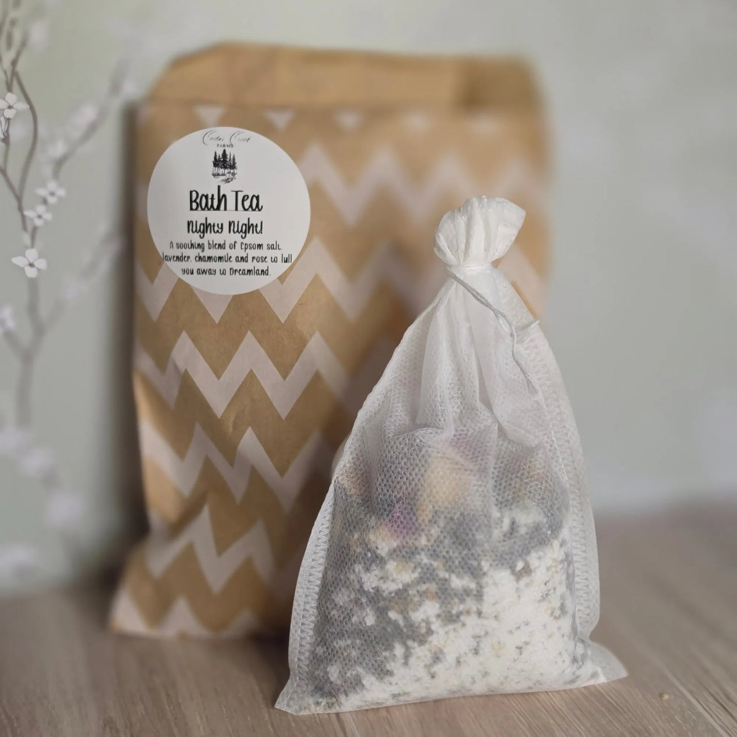 Cedar Creek Farms Bath Tea Nighty Night front packaging product view close-up showing herbal bath tea sachet with dried botanicals in front of labeled kraft pouch on wooden surface