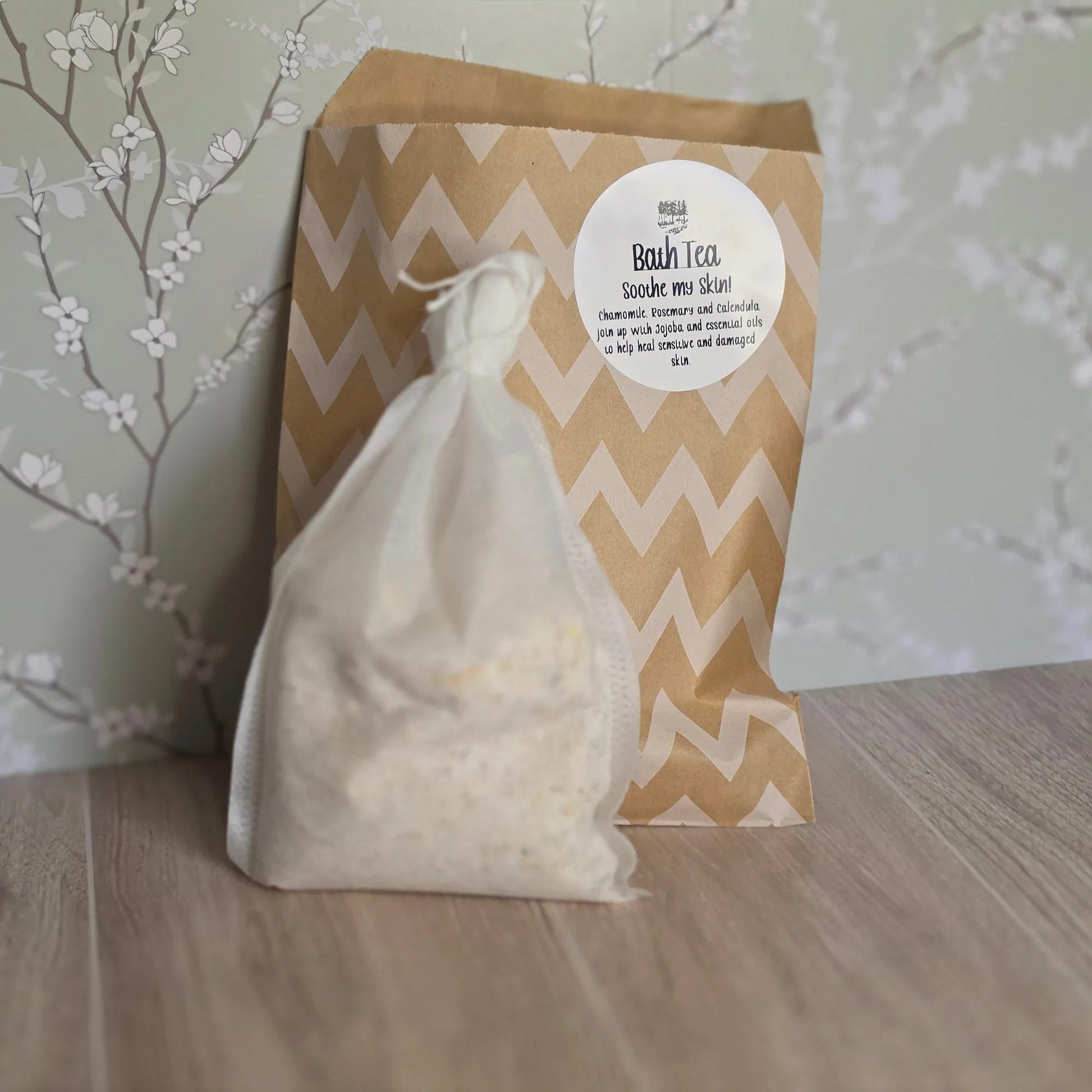 Cedar Creek Farms Bath Tea Soothe My Skin front packaging product view showing herbal bath tea bag and labeled kraft pouch on wooden surface