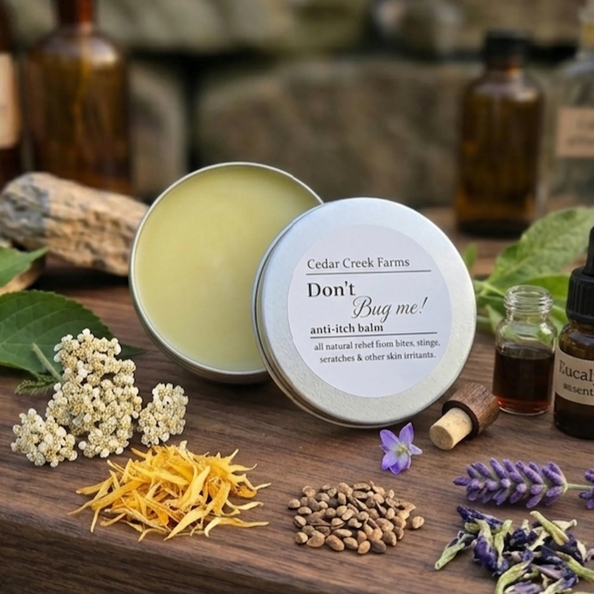 Cedar Creek Farms Don’t Bug Me anti itch salve with botanical ingredients and essential oils displayed on rustic wooden surface