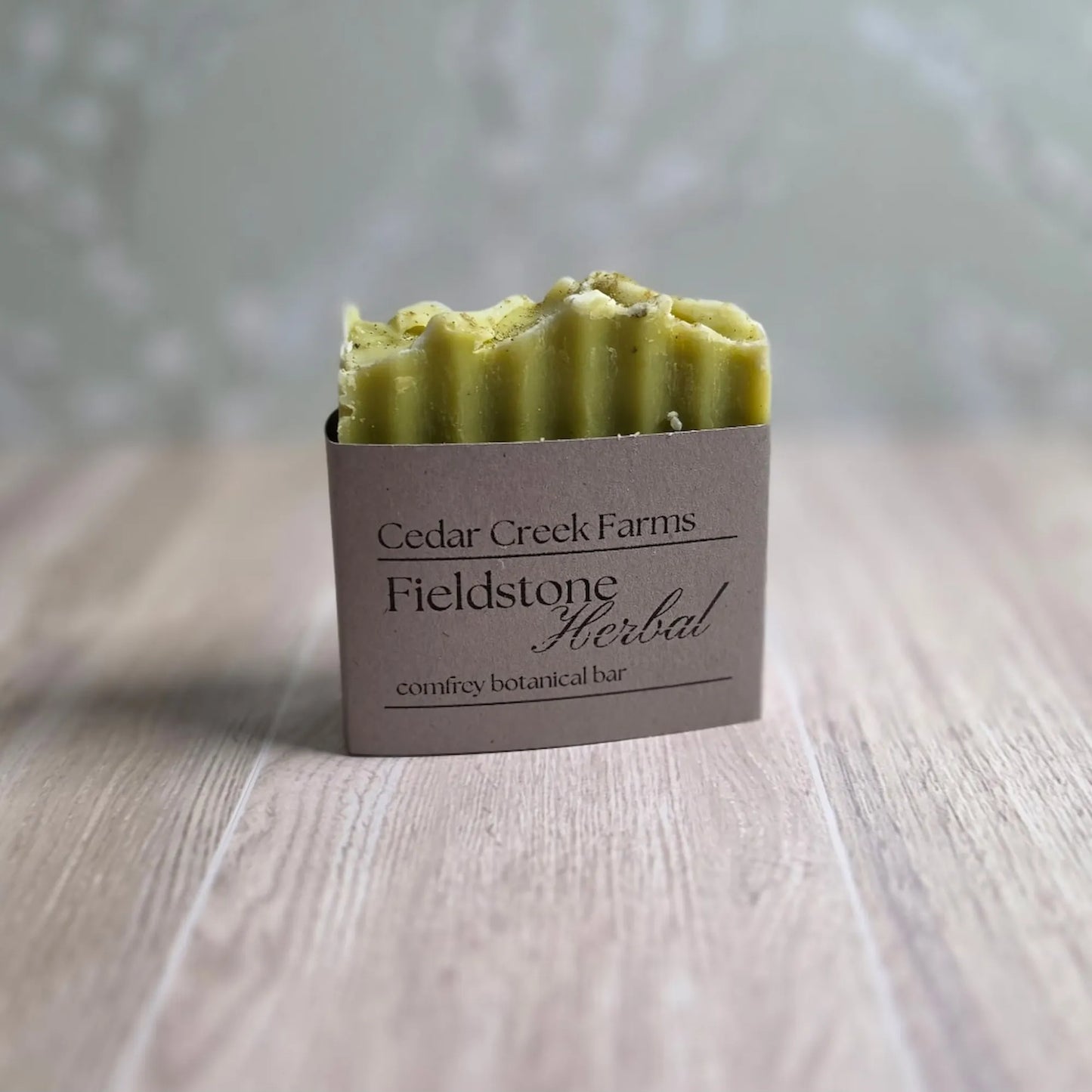 Cedar Creek Farms Fieldstone Herbal soap bar with green tone, natural handcrafted botanical soap on wood surface