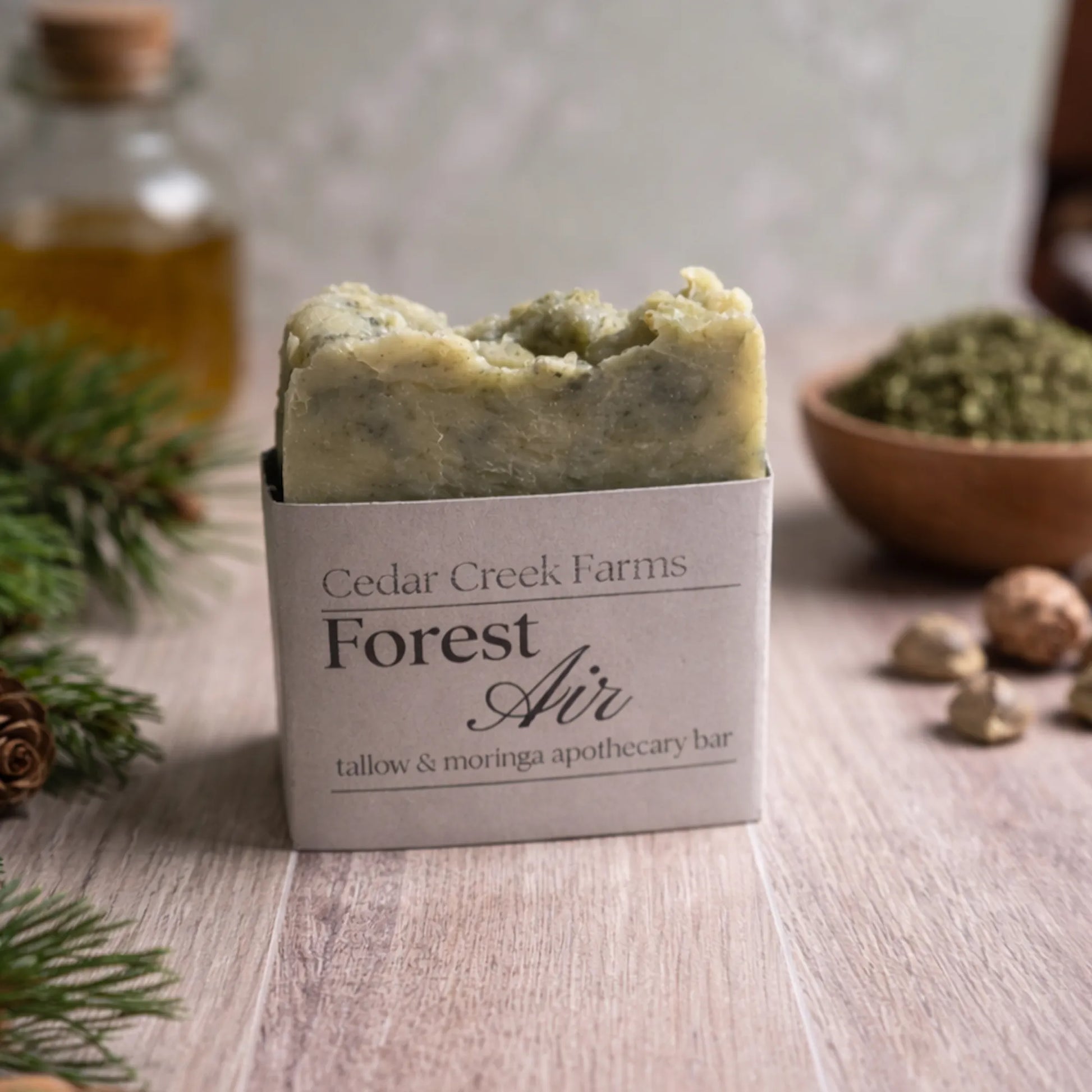 Cedar Creek Farms Forest Air tallow and moringa apothecary soap bar with pine and botanical ingredients on neutral wooden background