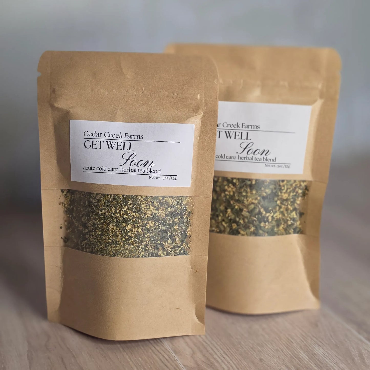 Cedar Creek Farms Get Well Soon Herbal Tea Blend product multiple package front view showing two labeled tea pouches with herbal blend on wooden surface