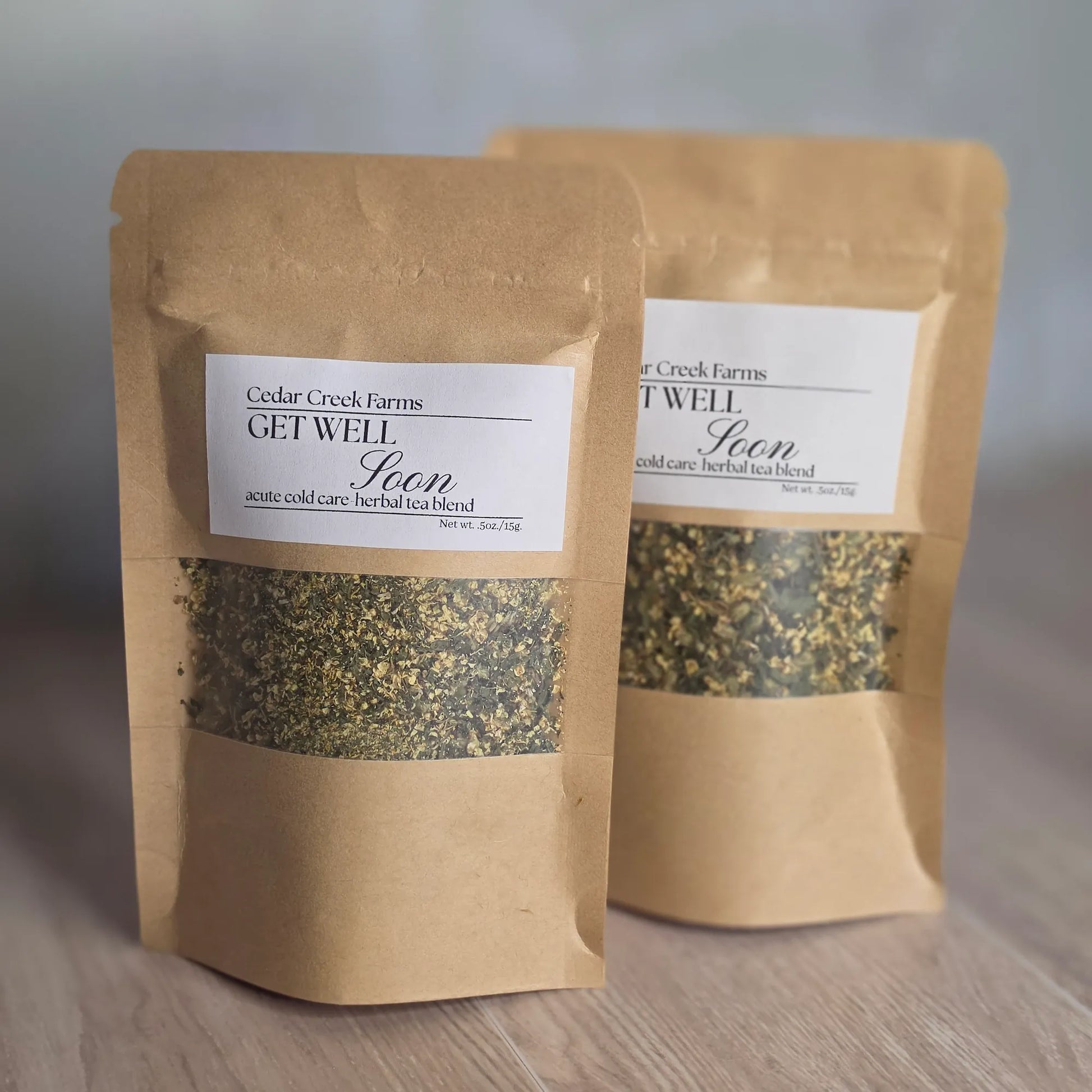 Cedar Creek Farms Get Well Soon Herbal Tea Blend product multiple package front view showing two labeled tea pouches with herbal blend on wooden surface