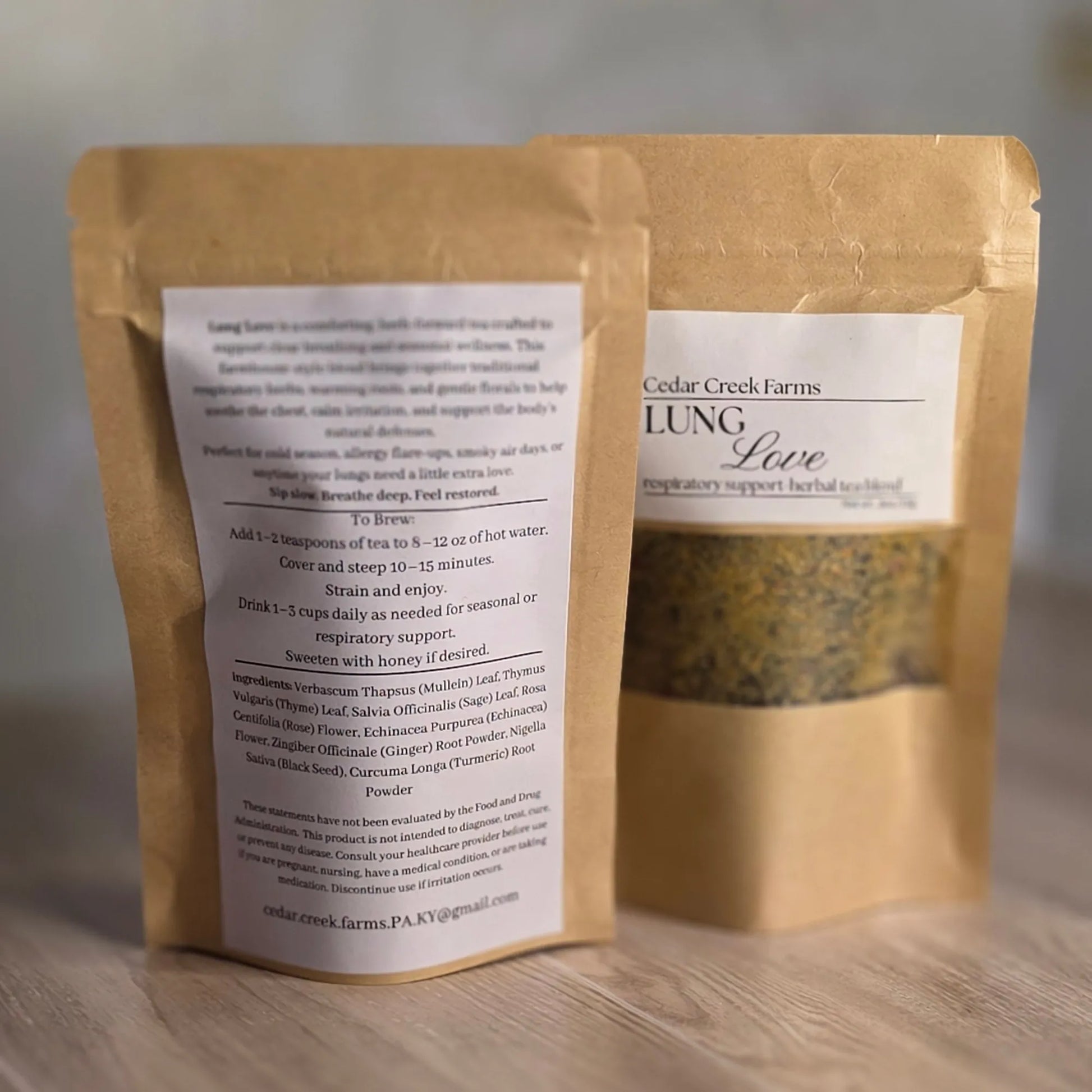 Cedar Creek Farms Lung Love Herbal Tea Blend front and back packaging product view showing labeled kraft pouch with loose leaf herbal tea and ingredient instructions on wooden surface