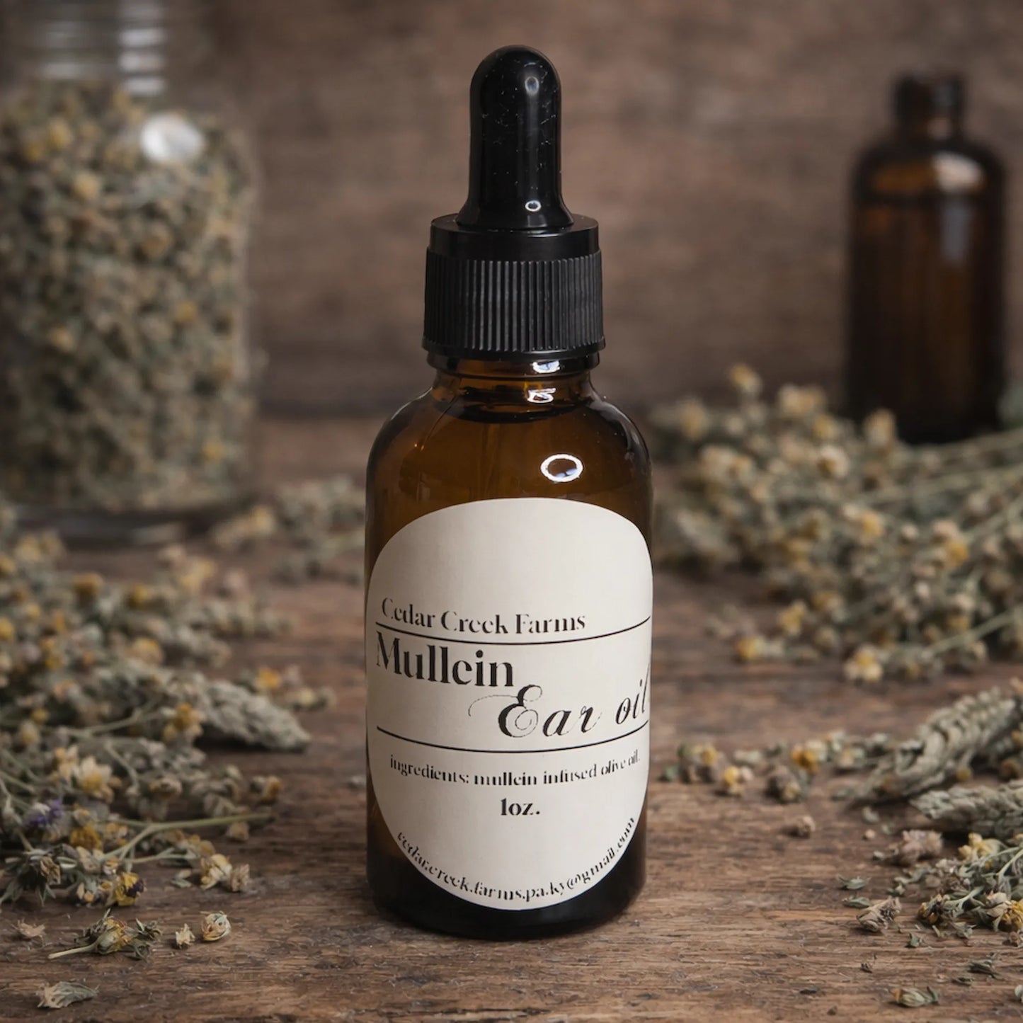 Cedar Creek Farms mullein ear oil natural herbal remedy dropper bottle with dried herbs on wooden surface
